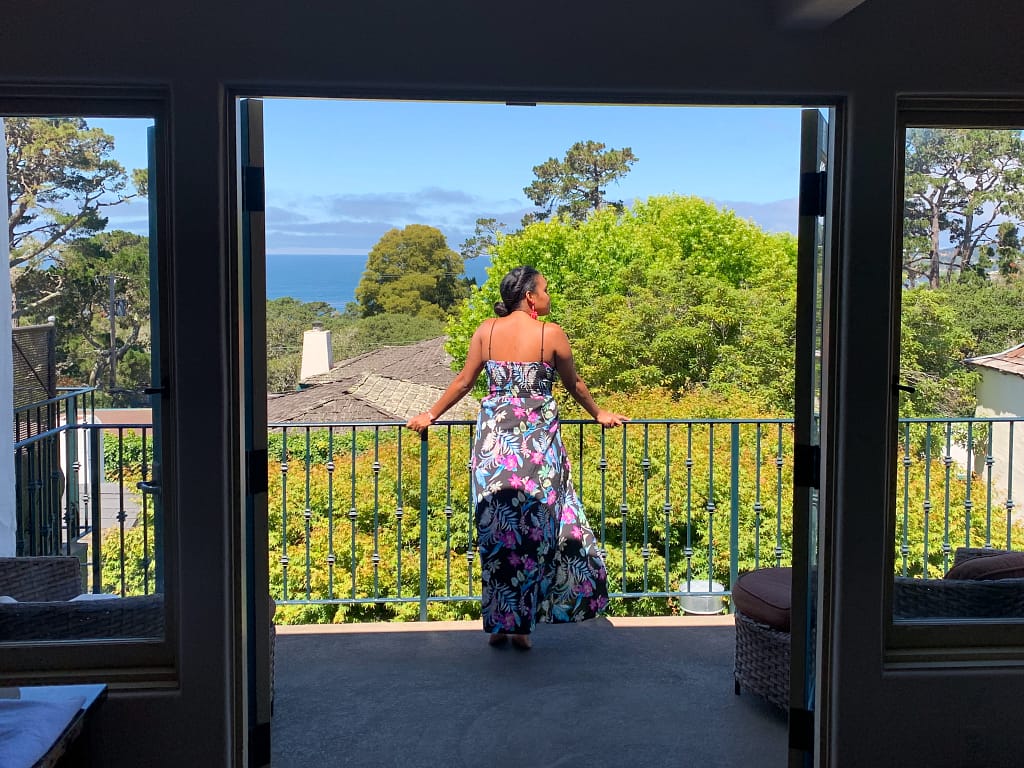 Girl standing on a balcony overlooking the below