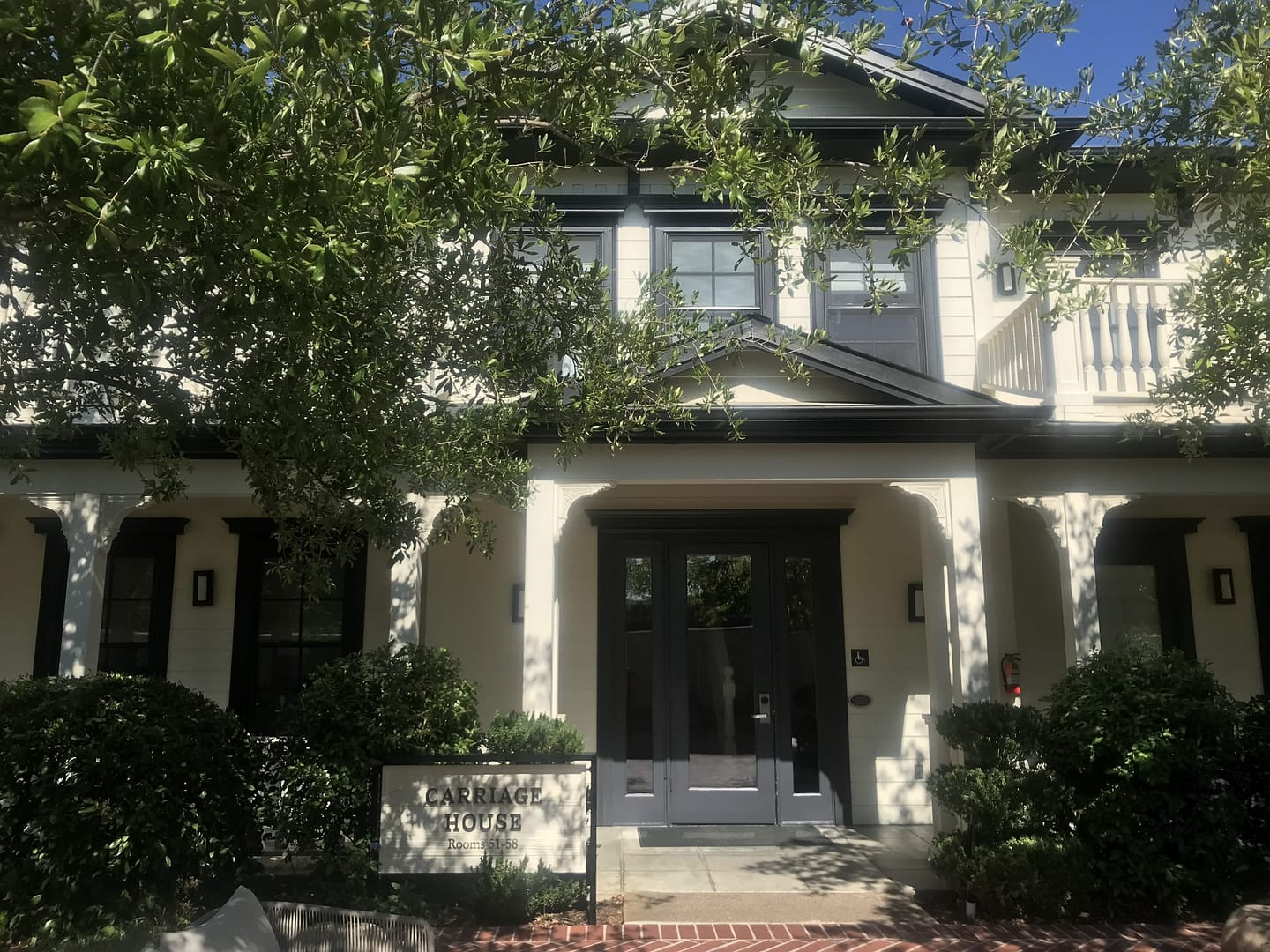 Picture of the exterior of a white hotel