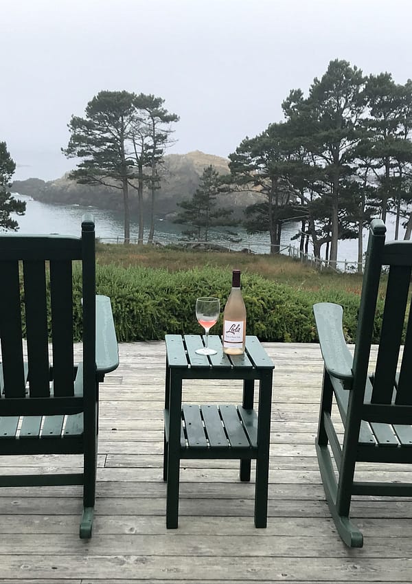 Rocking chairs on a patio deck overlooking the ocean
