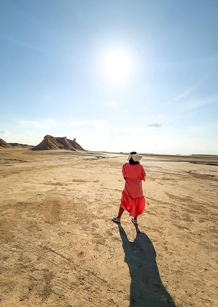 Girl standing in the Sahara desert in front of Ong Jmal mountain (Tunisia)