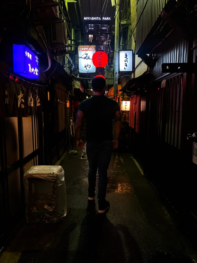 Man walking along Shibuya's Nonbei Yokocho (Drunkard's Alley).