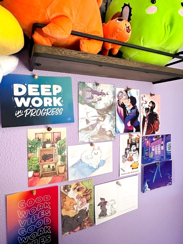 View of my office wall with different postcards pinned up
