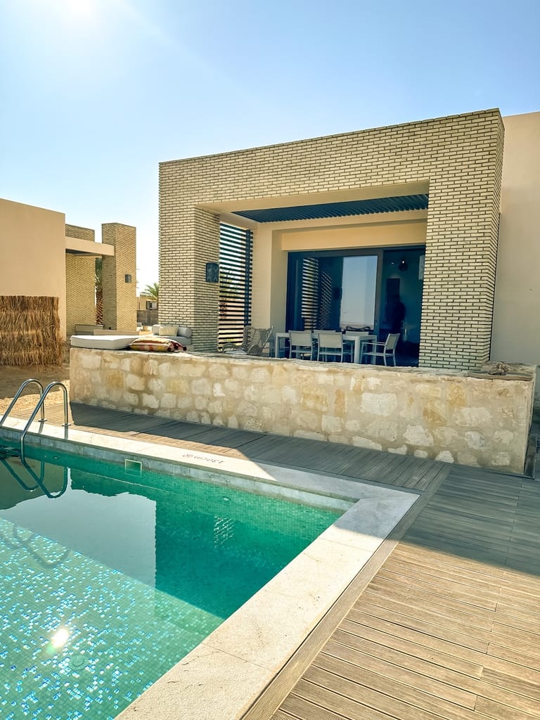 View of the pool and deck from the outside in the one-bedroom pool villa